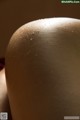 A close up of a woman's butt with water droplets on it.