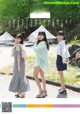 A group of young women standing next to each other on a road.