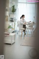 A woman sitting at a desk in an office.