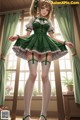 A girl in a green dress and stockings standing in front of a window.